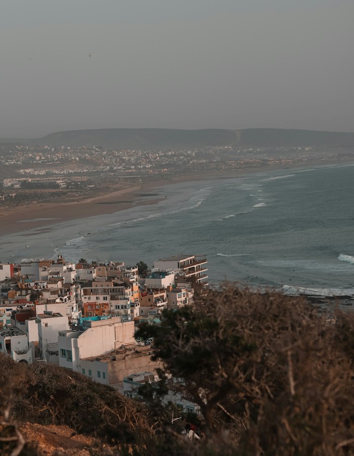 Coastal town of Taghazout with white buildings overlooking the Atlantic Ocean