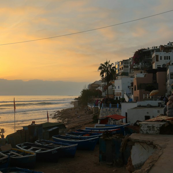 Coastal village at sunset with boats